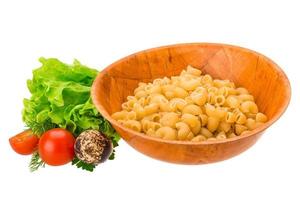 Raw pasta in a bowl on white background photo