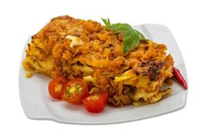 Italian Lasagna on the plate and white background photo