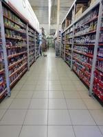 Jombang, East Java, Indonesia, 2022 - Nobody in A quiet shop aisle with rows of shelves filled with colorful household items or utensils . photo