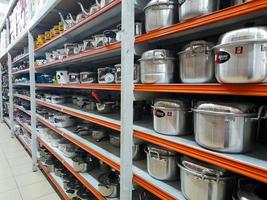 Jombang, East Java, Indonesia, 2022 - Rows of pan racks and various other kitchen utensils in supermarkets in Indonesia. portrait of display of household supplies in a shopping mall. photo