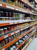 Jombang, East Java, Indonesia, 2022 - Rows of bread jam or eating from various famous brands in Indonesia and halal in supermarkets in Indonesia. portrait of delicious jam display in shopping mall. photo