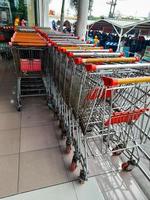 Jombang, Indonesia, 2022 - Rows of shopping cart trolleys that line up in large shopping centers can be used to make it easier for buyers to move places to carry a lot of groceries . photo