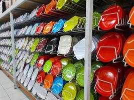 Rows of beautiful colorful plates lined up neatly on shopping mall shelves, can be used to serve dishes in culinary establishments such as restaurants. photo