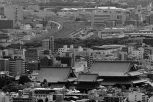 Kyoto temple and bullet train from mountaintop in black and white photo