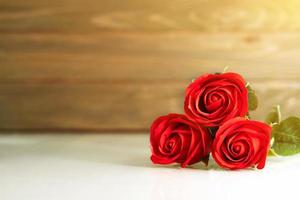 Red roses on table with copy space photo