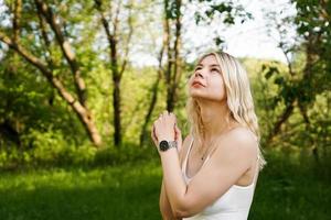 Beautiful young blonde in the forest. The girl enjoys nature photo