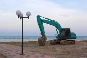 Excavator on sand photo