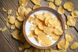 cornflakes bowl breakfast food and snack for healthy food concept, morning breakfast fresh whole grain cereal, cornflakes with milk on table food background photo