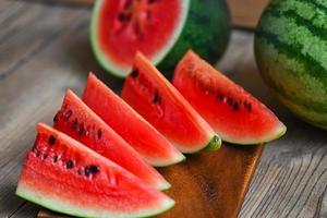 Watermelon slice on wooden background, Closeup sweet watermelon slices pieces fresh watermelon tropical summer fruit photo