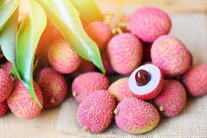 Lychee on the sack - Fresh lychee with green leaves harvest from tree tropical fruit summer in Thailand photo