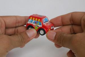 semarang, Indonesia january 20, 2020, hand holding a small red toy car photo