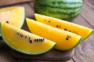 Yellow watermelon slice on wooden background, Closeup sweet watermelon slices pieces fresh watermelon tropical summer fruit photo