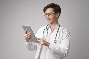 Portrait of male confident doctor over white background studio, healthcare and Medical technology concept. photo