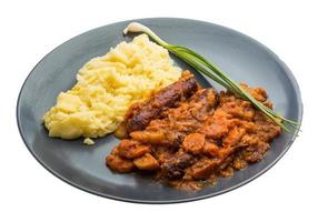 Dublin coddle on the plate and white background photo