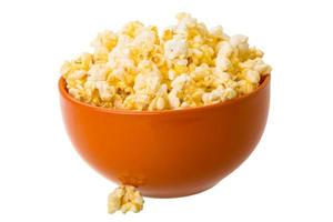 Popcorn in a bowl on white background photo