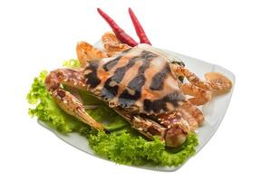 Red crab on the plate and white background photo