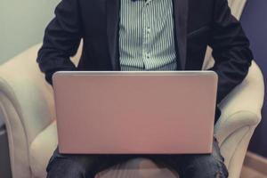 Unrecognizable businessman using laptop. photo