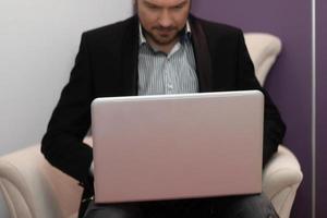 Close-up of businessman working on laptop. photo