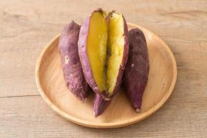 Grilled or baked Japanese sweet potatoes on wood plate photo