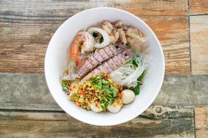 spicy seafood noodles bowl in Thai style photo