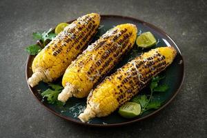 barbecue and grilled corn with cheese and lime photo