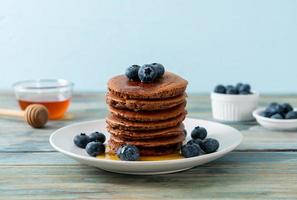 chocolate pancake stack with blueberry and honey photo