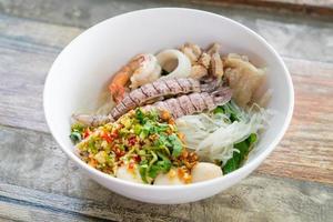 spicy seafood noodles bowl in Thai style photo