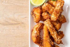 Fried Snapper Belly on white plate photo