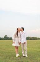 Happy young Asian couple in bride and groom clothing photo