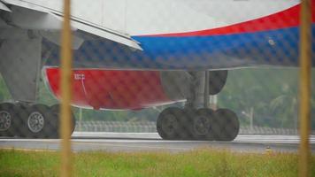 Close up gear and engine airplane taxiing before departure from Phuket airport video