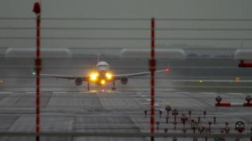 Airplane departure at rainy weather, early morning twilight. Dusseldorf airport video