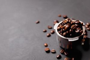 Hot fresh black coffee with milk foam for morning menu in white ceramic cup with coffee beans roasted on. photo