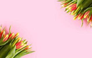 hermoso ramo de tulipanes rosa pastel, borde floral en fondo claro, vista superior. diseño para vacaciones de primavera. tarjeta de felicitación del día de la madre foto