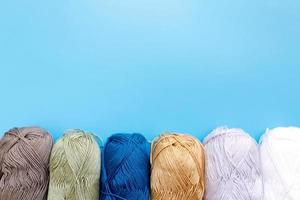 Skeins of wool yarn and knitting needles photo