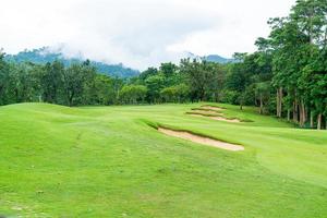 Green with Sand bunkers on Golf course photo