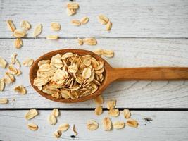 Old fashioned rolled oats in wooden spoon. photo