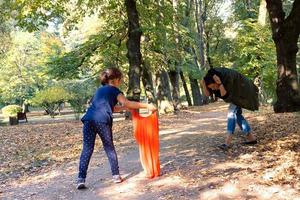 Small girl having fun while playing with her mother in nature. photo