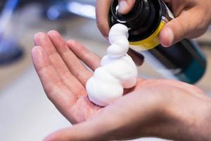 Shaving foam in hand. photo