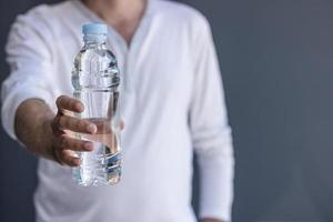 Unrecognizable man holding bottle of water. photo