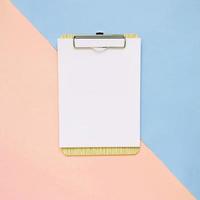 Blank clipboard on pastel color background, minimal style photo