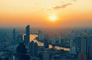 Beautiful cityscape with sunset and twilight night aerial view of Bangkok. Taking from Mahanakhon Tower Famous skyscrapers of Bangkok. photo