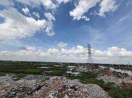 Jakarta, Indonesia in August 2022. An illegal garbage dump on the bank of the East Flood Canal. It causes pollution in the surrounding environment photo