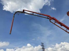 This is a process of casting concrete using a concrete pump to reach casting locations that are far away. photo