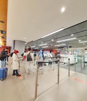 Istanbul, Turkey on July 2022. Several tourists are queuing for passport checking at the passport control counter, both local and international tourists. photo