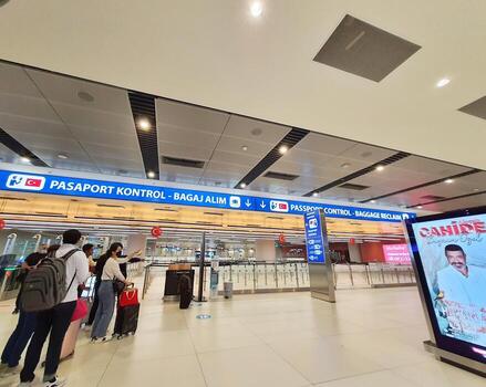 Istanbul, Turkey on July 2022. Several tourists are queuing for passport checking at the passport control counter, both local and international tourists. photo