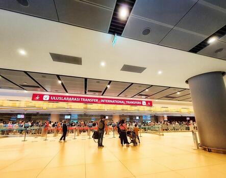 Istanbul, Turkey on July 2022. Several tourists are queuing for passport checking at the passport control counter, both local and international tourists. photo