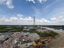 Jakarta, Indonesia in August 2022. An illegal garbage dump on the bank of the East Flood Canal. It causes pollution in the surrounding environment photo