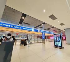Istanbul, Turkey on July 2022. Several tourists are queuing for passport checking at the passport control counter, both local and international tourists. photo