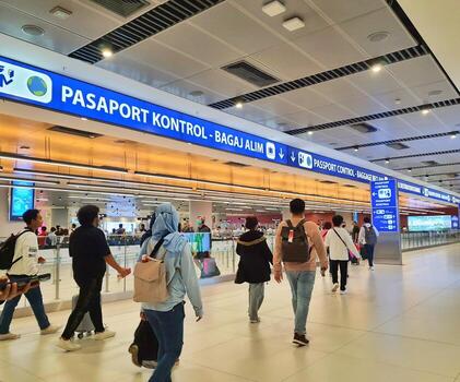 Istanbul, Turkey on July 2022. Several tourists are queuing for passport checking at the passport control counter, both local and international tourists. photo