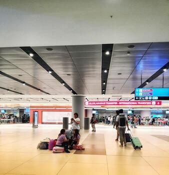 Istanbul, Turkey on July 2022. Several tourists are queuing for passport checking at the passport control counter, both local and international tourists. photo